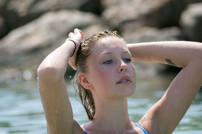 Close-up of woman with hand in wet hair