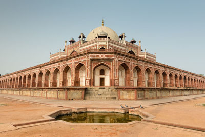 Facade of historical building against clear sky