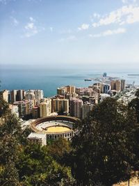 High angle view of buildings and sea against sky