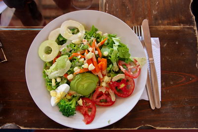 Top shot of mixed salad on the rustic wooden table