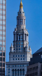 Low angle view of buildings against blue sky