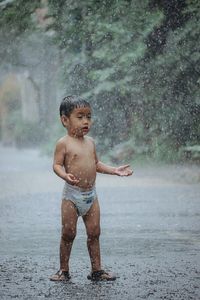 Portrait of shirtless boy playing in water