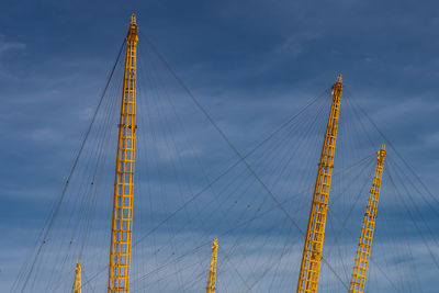 Low angle view of suspension bridge against sky