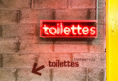 Close-up of text on red wall