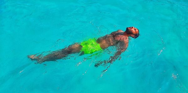 High angle view of man swimming in sea