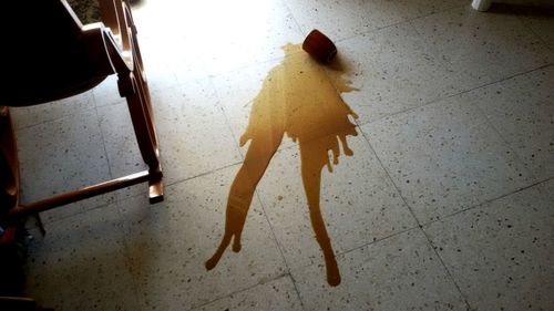 Coffee spilled on tiled floor