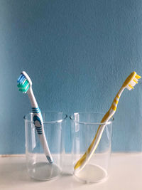 Close-up of drinking glass against blue background