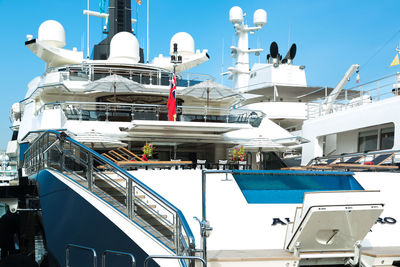 Ship moored at harbor against blue sky