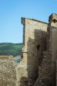 Old ruin building against blue sky