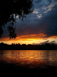 Scenic view of lake against cloudy sky