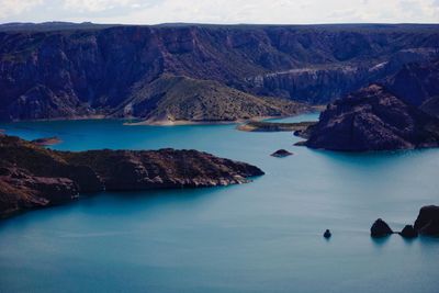 High angle view of seascape by mountains