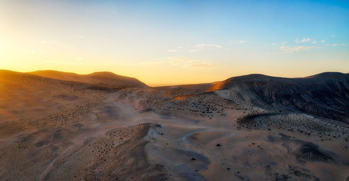 Scenic view of mountains against sky during sunset