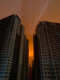 Low angle view of buildings against sky during sunset