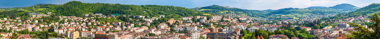 Panoramic view of trees and buildings against sky