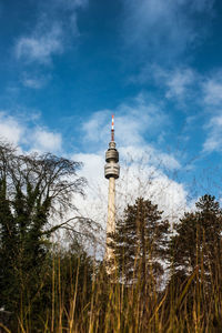 Low angle view of tower against cloudy sky