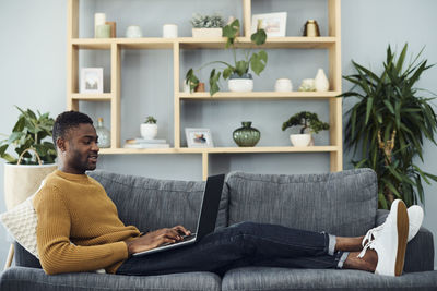 Man sitting on sofa at home