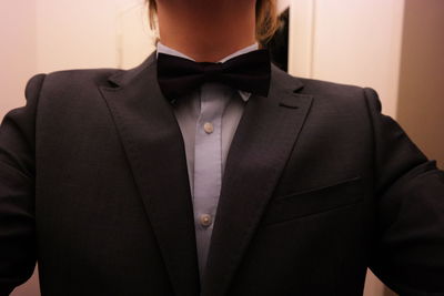 Midsection of businessman wearing tuxedo in office