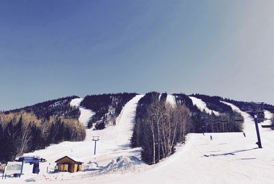 Snow covered landscape against sky