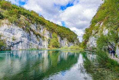 Scenic view of lake by trees against sky