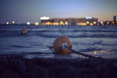 Close-up of illuminated lighting equipment on beach