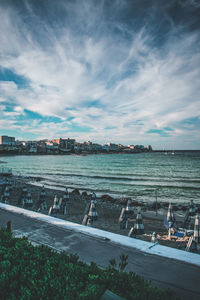 High angle view of sea and city against sky