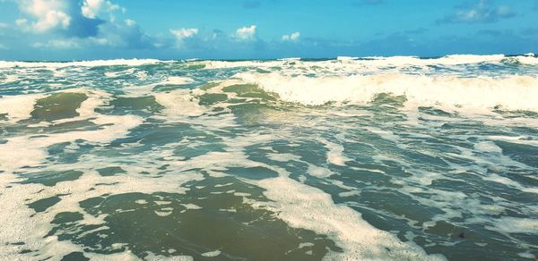 Surface level of beach against sky