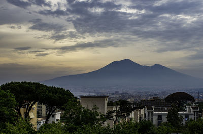 View of townscape against cloudy sky