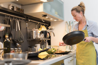 Woman preparing food in kitchen