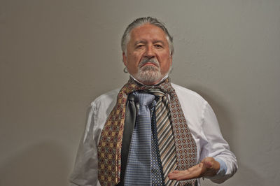 Portrait of a man standing against wall