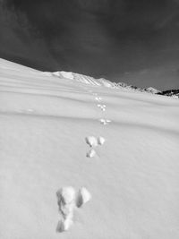 Scenic view of snow covered land against sky