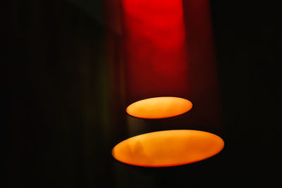 Close-up of illuminated lights against black background