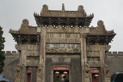 Statue in temple against sky in city