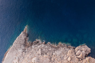 High angle view of rock formation by sea