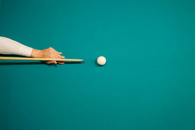 Cropped hand of person playing pool