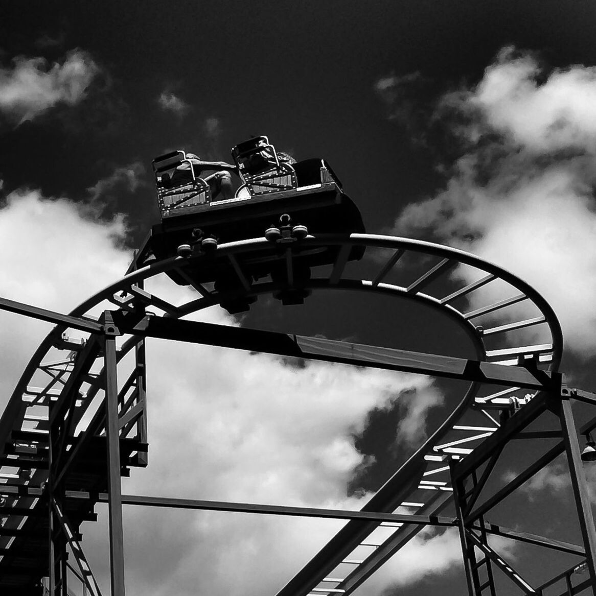 low angle view, sky, cloud - sky, cloudy, metal, cloud, amusement park, arts culture and entertainment, built structure, metallic, technology, amusement park ride, outdoors, day, connection, no people, silhouette, architecture, overcast, ferris wheel