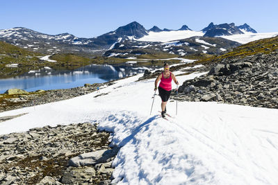 Woman cross-country skiing in mountains