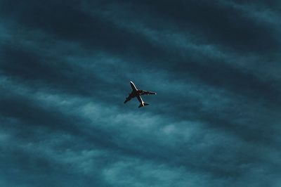 Low angle view of airplane flying in sky