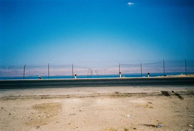 View of calm beach against blue sky