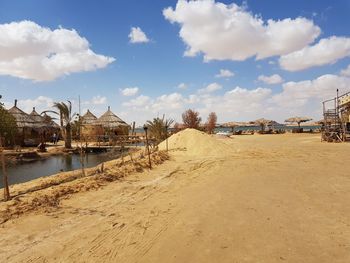 Panoramic view of beach and buildings against sky