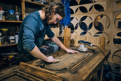 Side view of man working in workshop