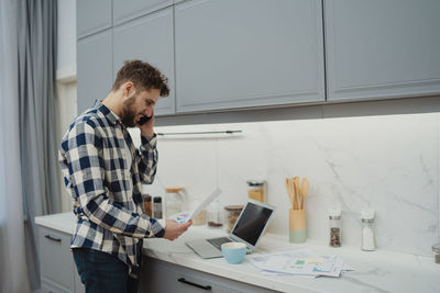 Side view of man working at home