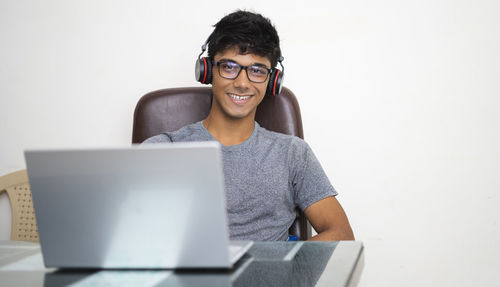 Portrait of smiling young man using mobile phone