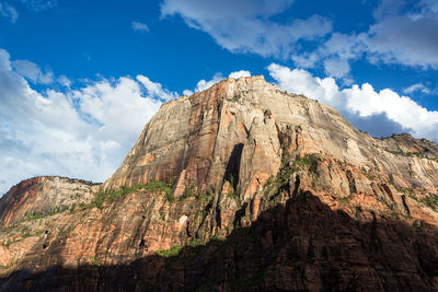 Low angle view of mountain against cloudy sky