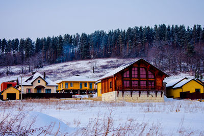 Houses on snow covered field