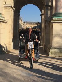 Portrait of man riding bicycle in city