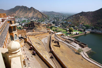 High angle view of amer fort by mountains and residential district