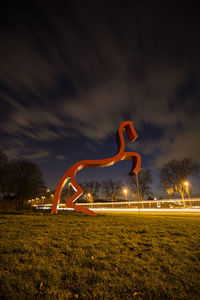 Built structure on field against sky at night