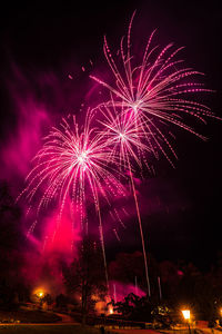 Low angle view of firework display at night