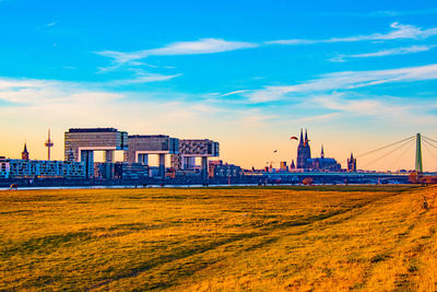 Buildings in city against cloudy sky