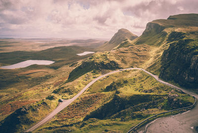 Scenic view of mountains against cloudy sky